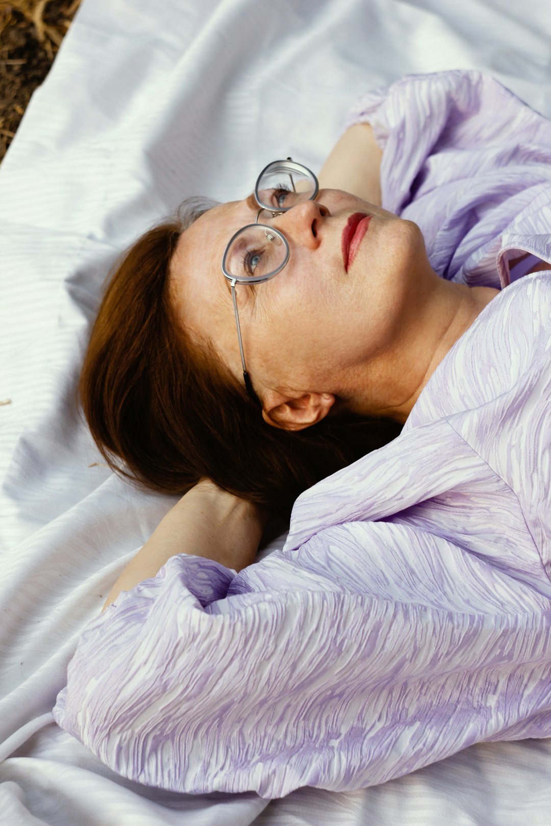 A Woman With Glasses Laying On A Blanket Qoutohi9jp0