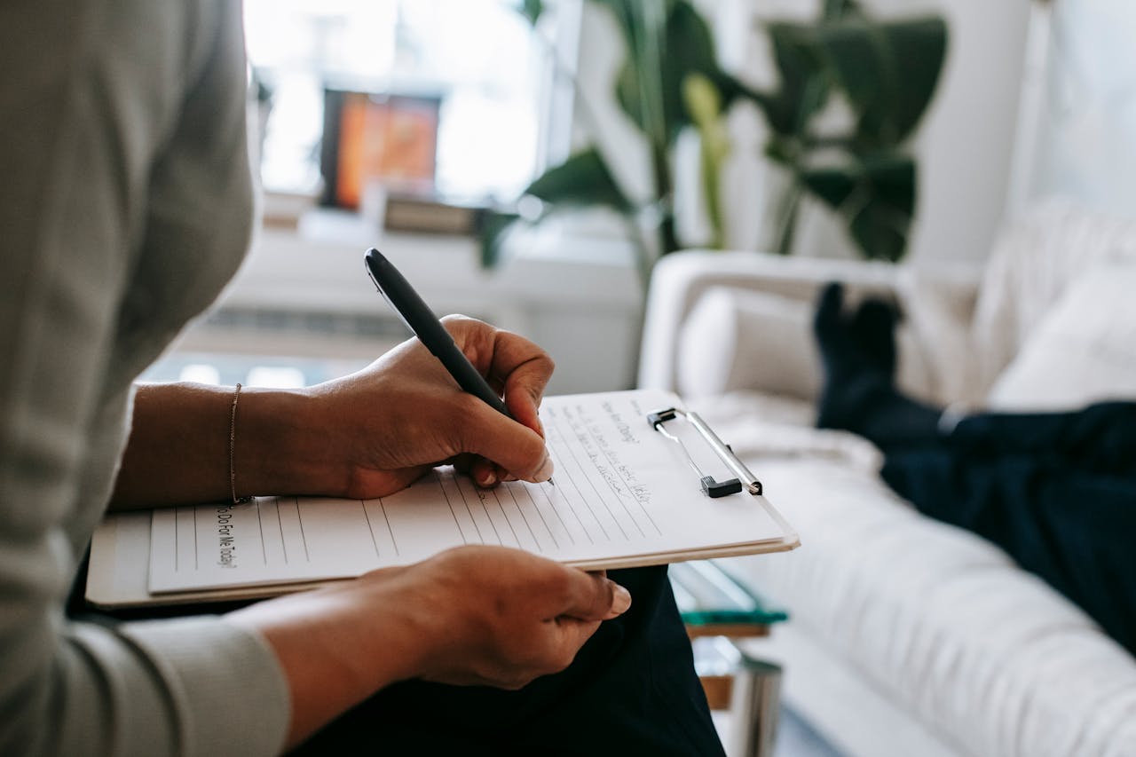 heros-img Crop Ethnic Psychologist Writing On Clipboard During Session 5699456
